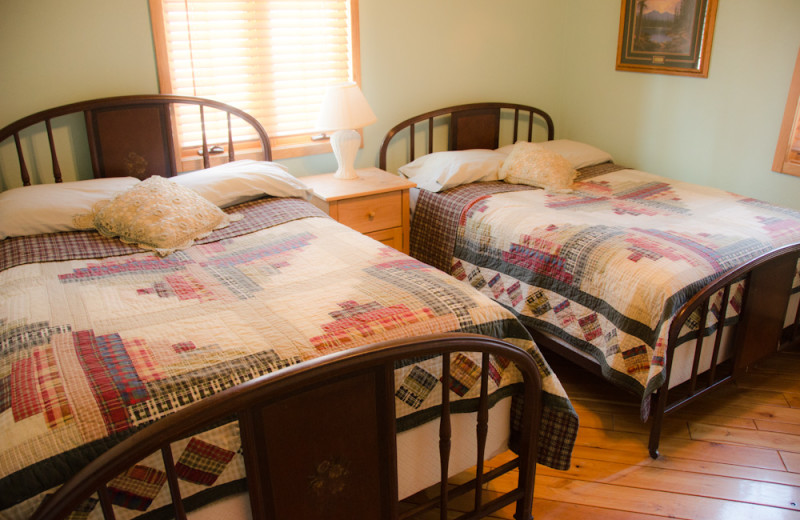 Cabin bedroom at Tri Lake Timbers Resort.