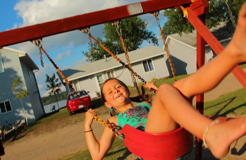 Kid on swing at Auger's Pine View Resort.