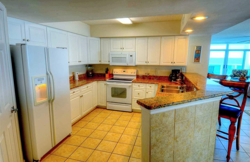 Rental kitchen at CondoLux Vacation Rentals.