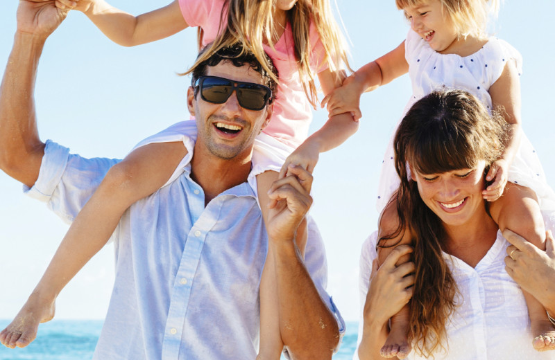 Family on beach at Island Real Estate.