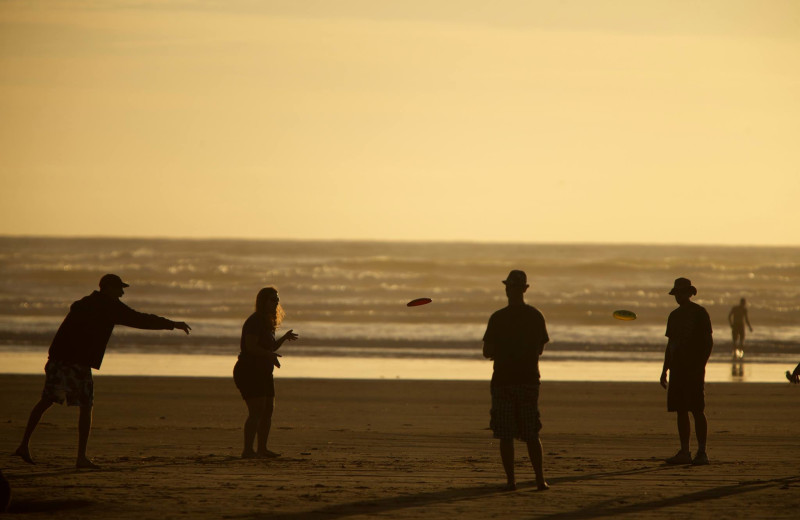 Family on beach at Seabrook Cottage Rentals.