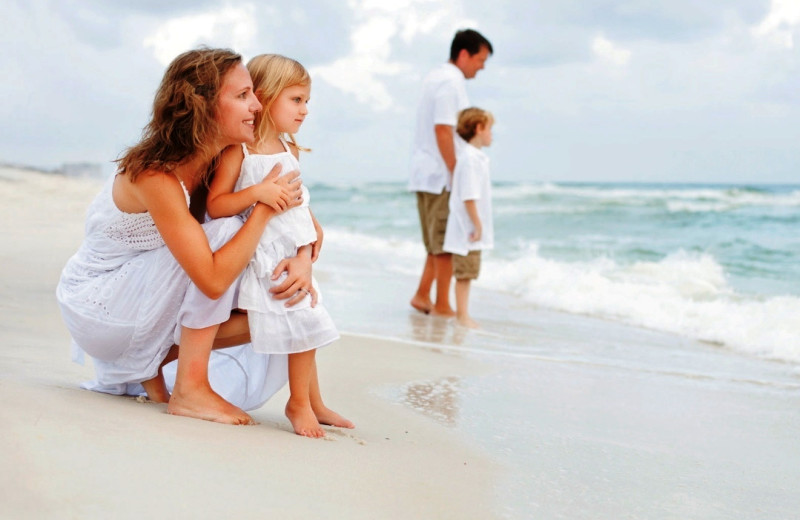 Family on beach at Newman-Dailey Resort Properties, Inc. 