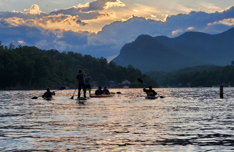 Family kayaking and paddle boarding at Yonder Luxury Vacation Rentals.