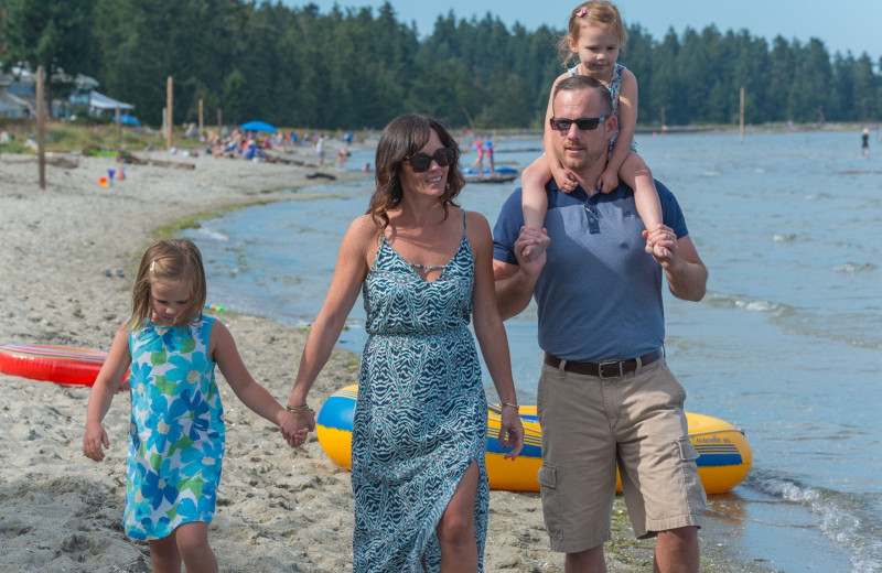 Family on beach at Tigh-Na-Mara Resort.