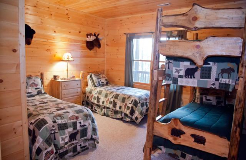 Cabin bedroom with bunk beds at Mountain Getaway Cabin Rentals.