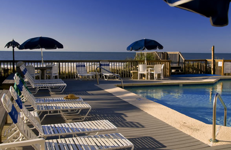 Lounge chairs by pool at Ocean Isle Inn.