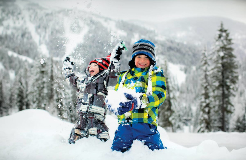 Kids playing in snow at Kandahar Lodge.