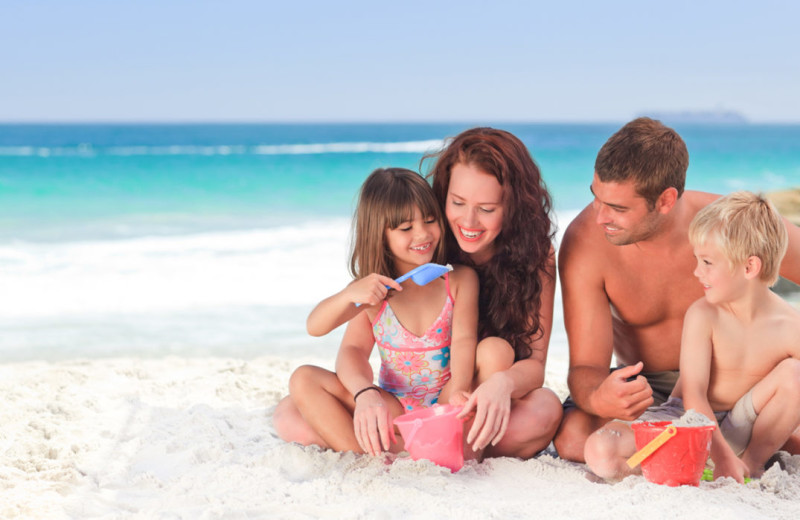 Family on beach at Together Resorts.