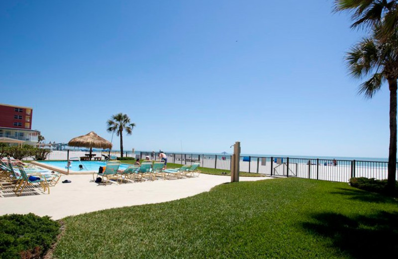 Outdoor pool and beach at Resort Rentals.