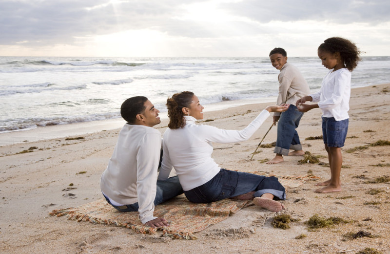 Family on beach at Vacation Rentals by McLain Properties.