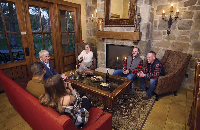 A family chatting next to a fireplace