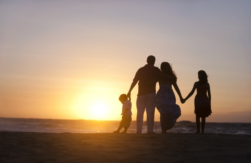 Family on beach at The Palms of Destin Resort & Conference Center.
