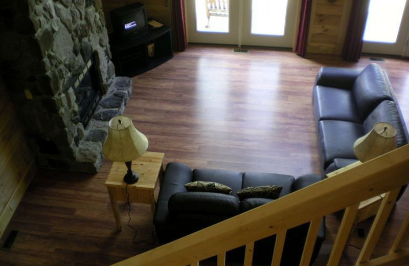 Cabin living room with fireplace at Harman's Luxury Log Cabins.