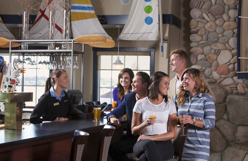 Unwind at On the Rocks Bar & Grill at Blue Harbor Resort for Happy Hour and Lake Michigan views.