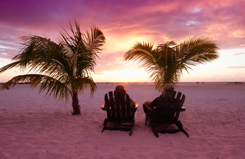 Couple on beach at Lighthouse Resort Inn & Suites.