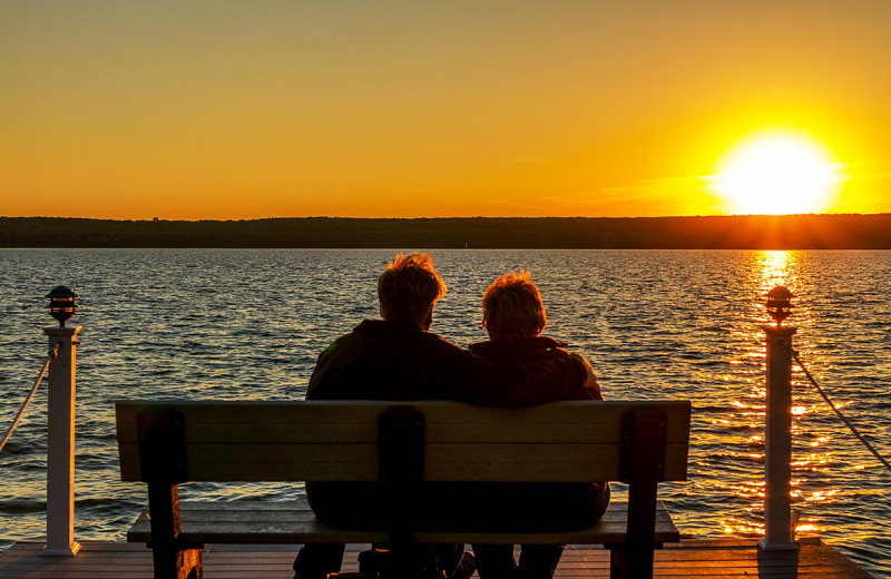 Couple on dock looking at sunset at Bay Shore Inn.