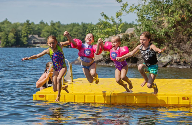 Jumping in lake at Great Blue Resorts- Lantern Bay Resort.