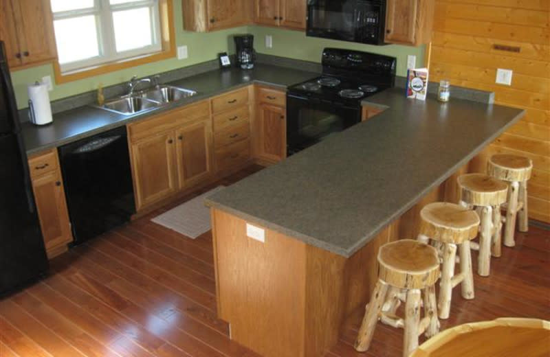 Breakfast bar and kitchen in Moonlight Bend Cabin at Red Cedar Lodge. A great place to cook together and feed your family.