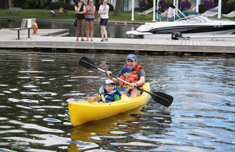 Father and son paddling a canoe at Fern Resort