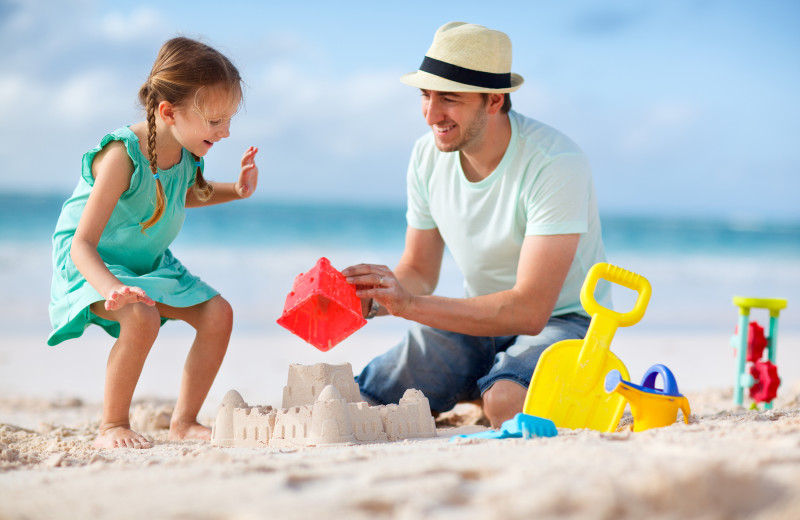 Family on beach at Gary Greene Vacation Rentals.