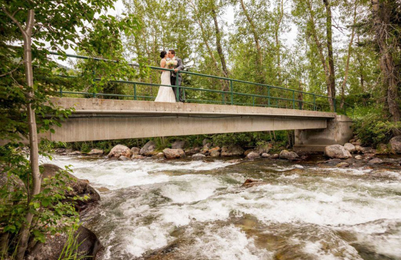 Wedding couple on bridge over creek at Rock Creek Resort.