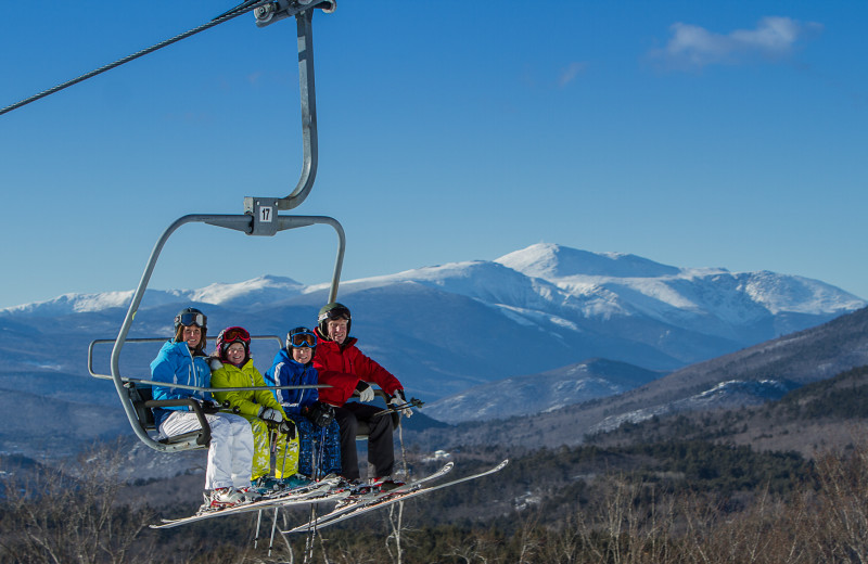 Family on ski lift near Attitash Marketplace Motel.