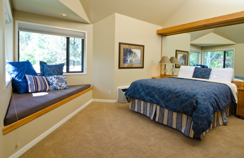 Hotel room with queen bed, window seat, coffee maker and mini fridge at Mount Bachelor Village Resort.