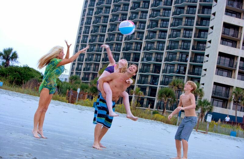 Family playing on beach at Ocean Reef Resort.