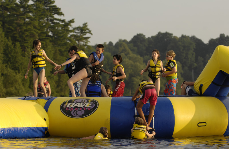 Jumping on the water trampoline at Tyler Place Family Resort.