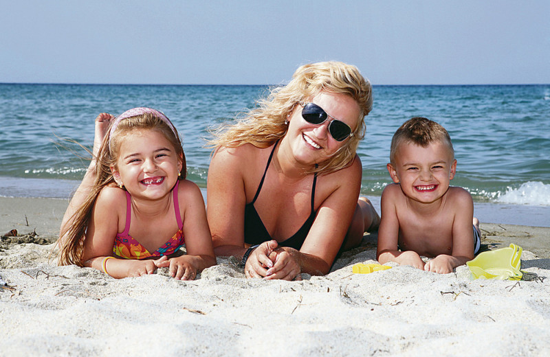 Family on the beach at Water's Edge Resort.