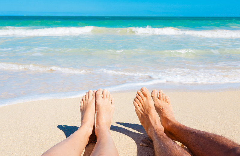 Couple on beach at Beach Realty.