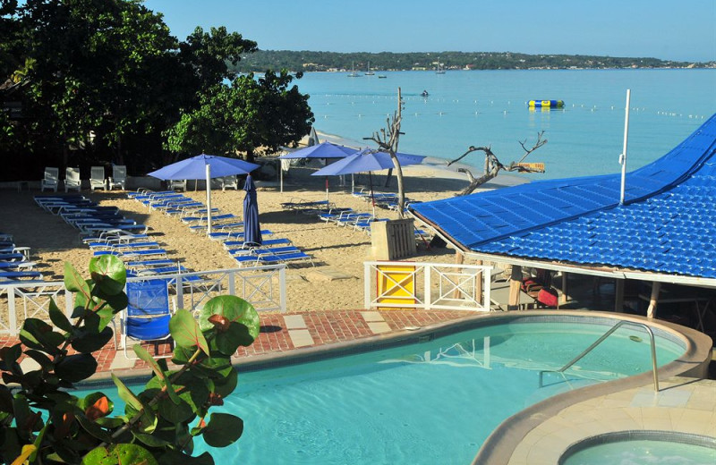 Outdoor pool and beach at Negril Tree House Resort.