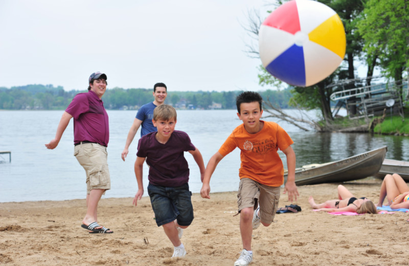 Family on beach at Baker's Sunset Bay Resort.