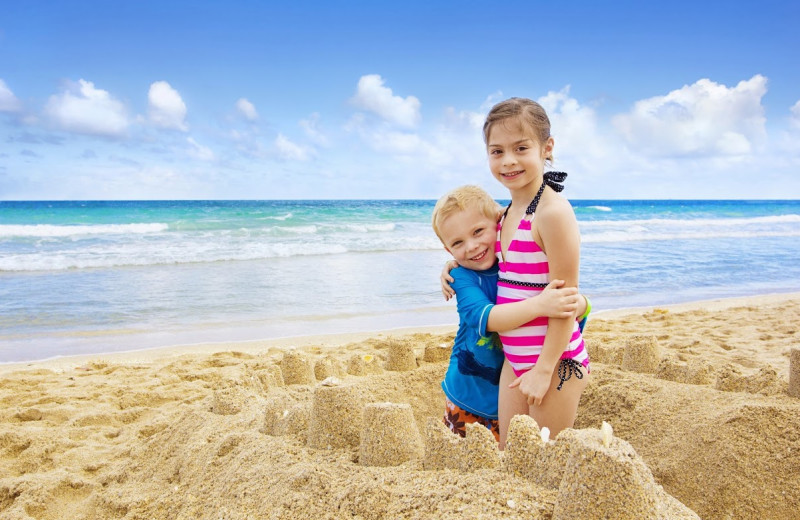 Family on beach at Shoreline Properties.