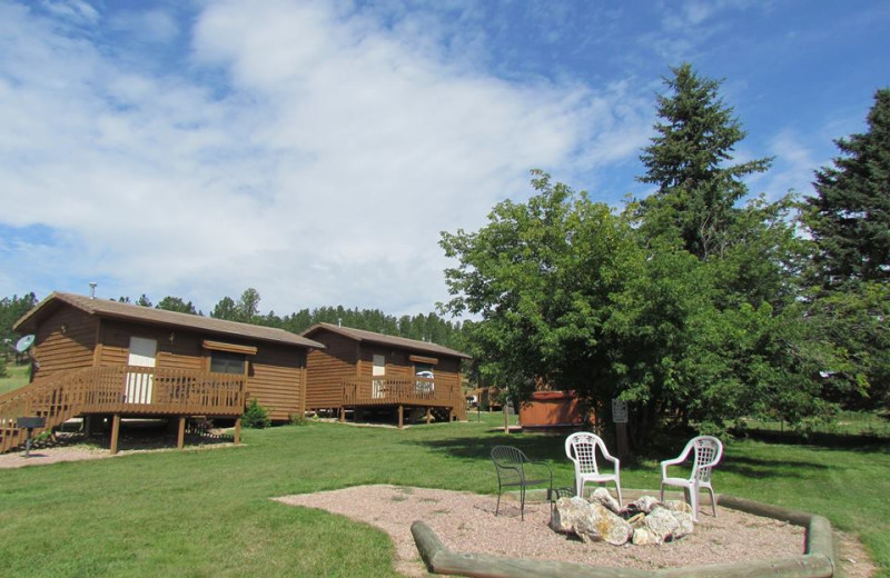 Cabins by a fire pit at High Country Guest Ranch.