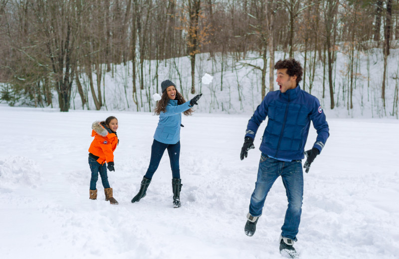 Family in snow at Fairmont Le Chateau Montebello.