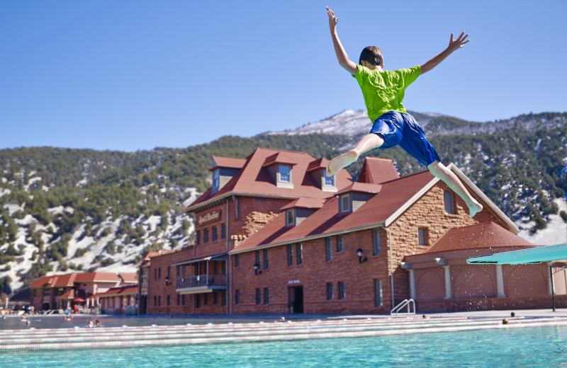 Kid jumping in pool at Glenwood Hot Springs.