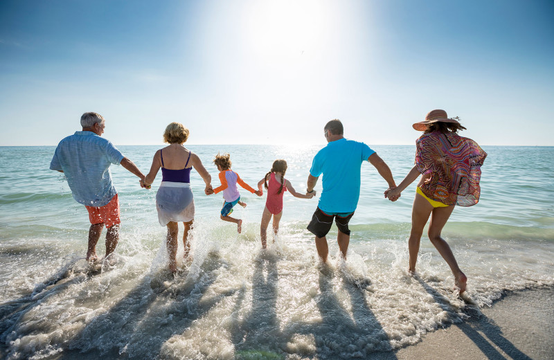 Family on beach at TradeWinds Island Grand.