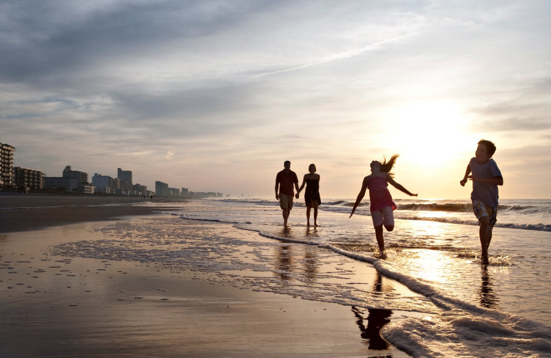 Family on the beach at Ocean Creek Resort.