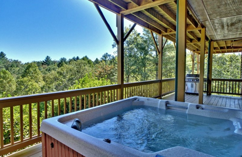 Deck view with jacuzzi at Southern Comfort Cabin Rentals.