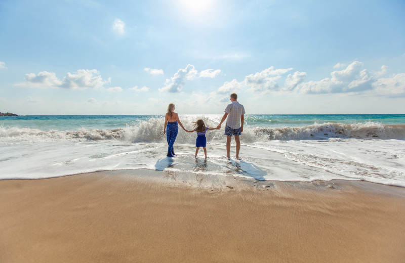 Family on beach at Palm Suites.