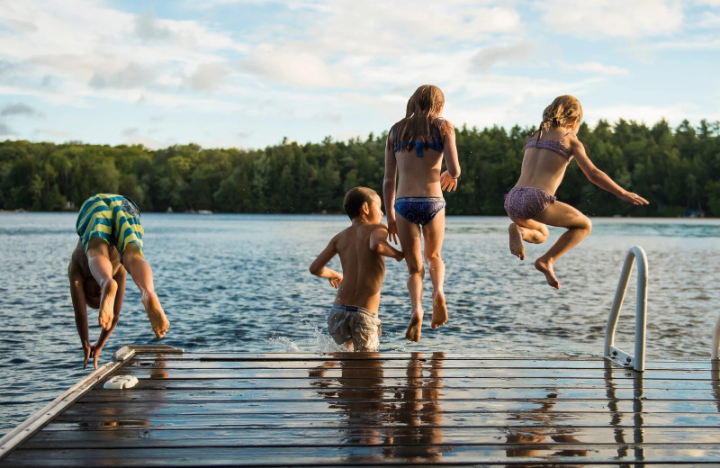 Jumping in lake at Sand Lake Resort.