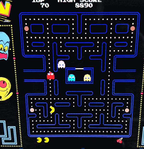 A PAC-MAN arcade cabinet, lit and waiting for a coin.