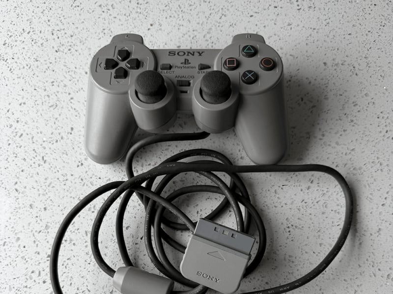 The away controller A worn-out PlayStation 1 controller.