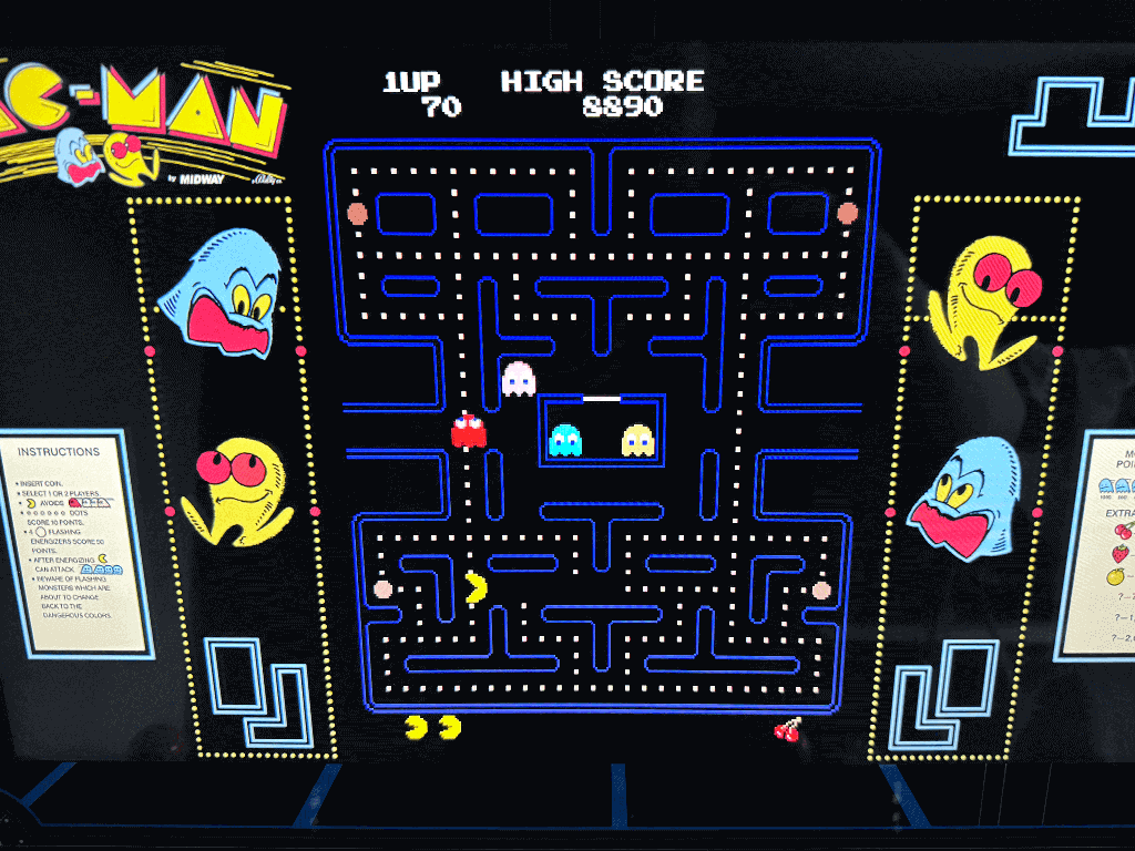 Pacman A close up of an arcade playing the Pacman arcade game.