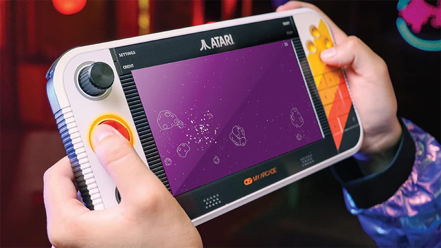 Close-up of someone playing the Atari Game Station Go handheld