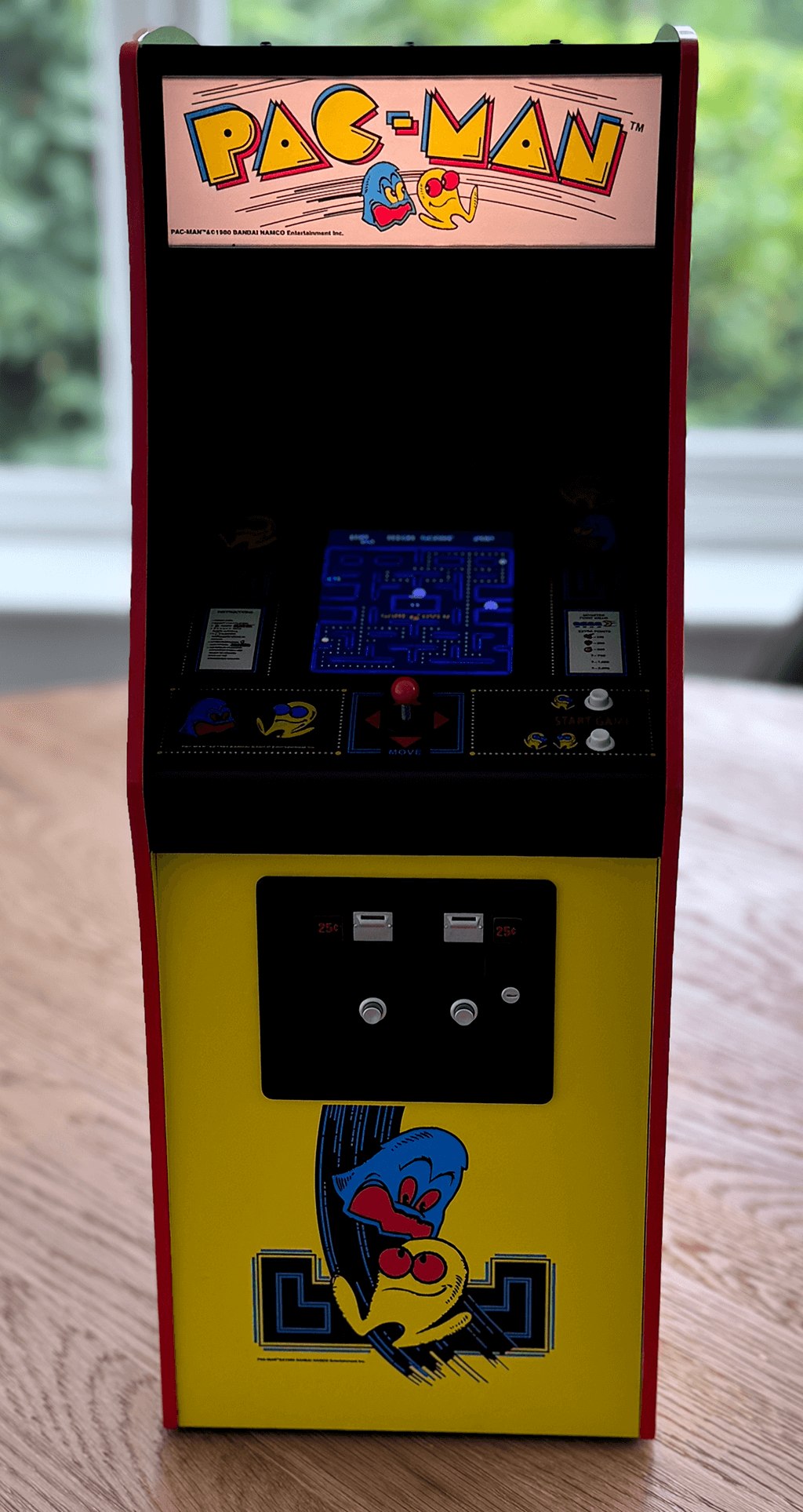 A front view of a PAC-MAN quarter arcade Machine.