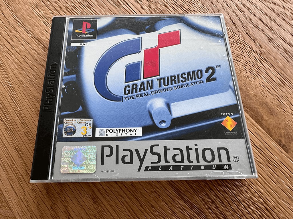 Gran Turismo A copy of the Playstation 1 Gran Turismo 2 game in a case in a wooden table top