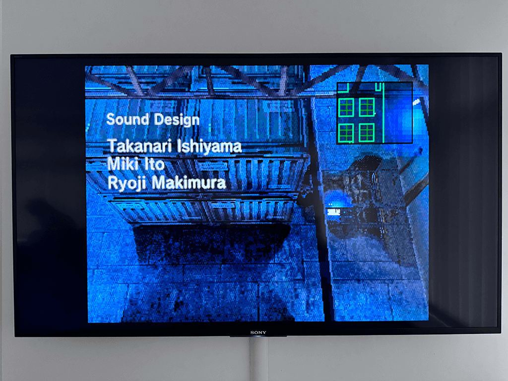 Metal Gear Solid A wall mounted Sony TV dispalying the Metal Gear Solid game.