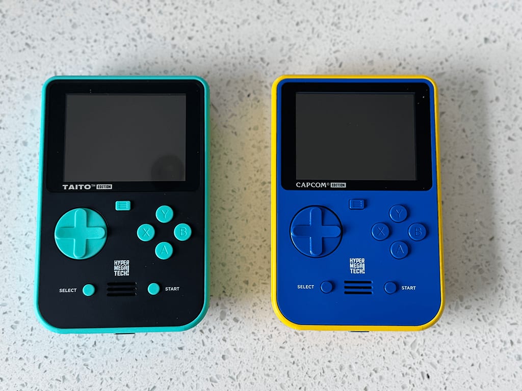 The front of Taito and Capcom Super Pockets out of the packaging on a wooden table top.